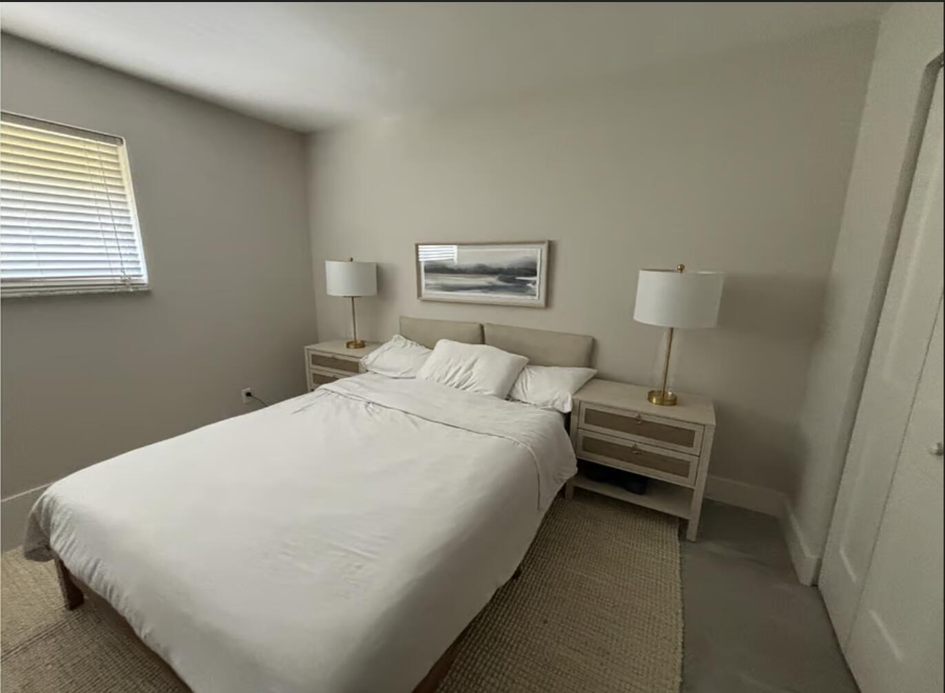 1822 Windsor Drive, Unit 1 Juno Ridge, FL 33408 - Photo 3 of 12 a bedroom with a bed and a window