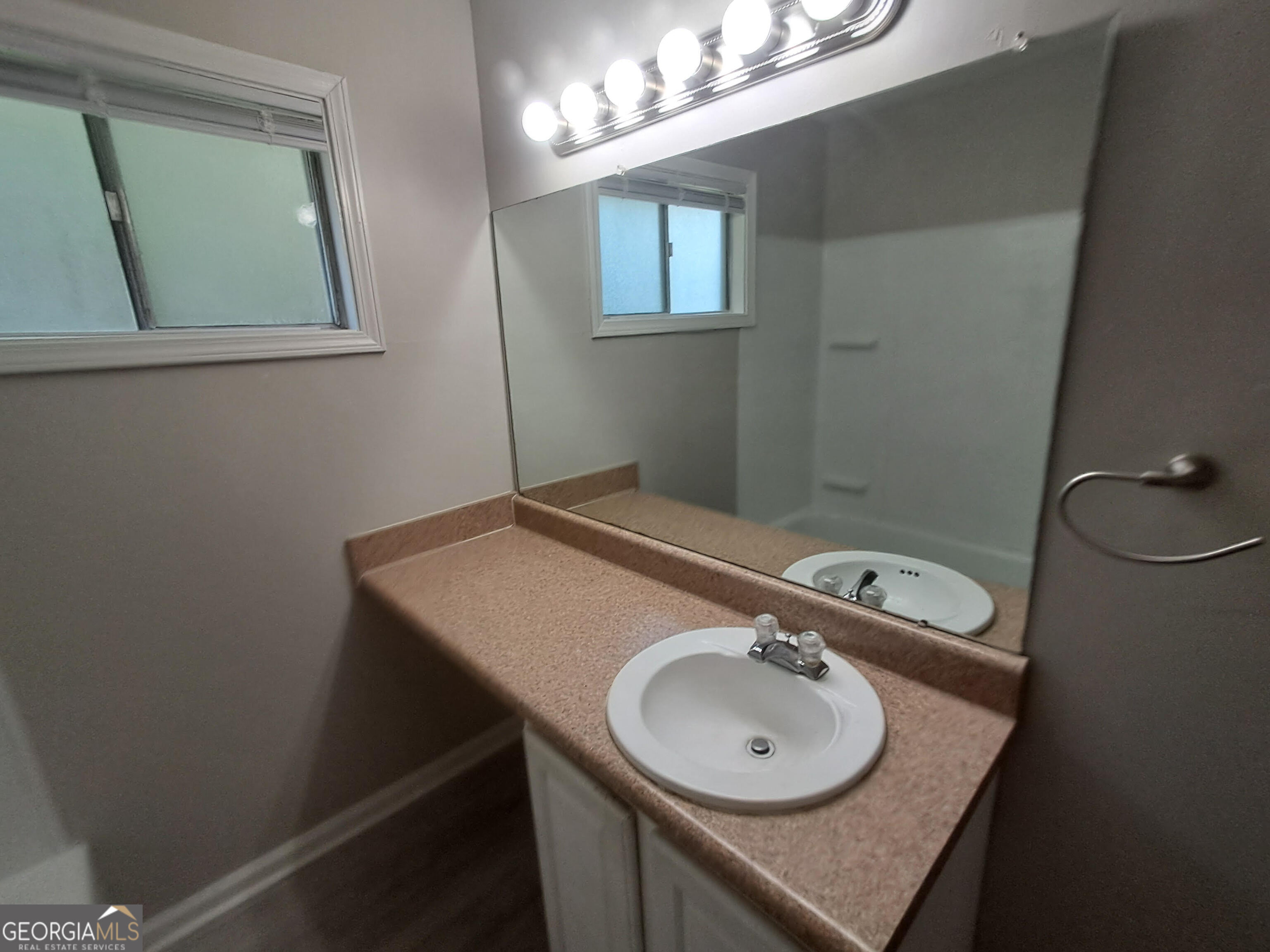 193 Frazier Drive Southeast Milledgeville, GA 31061 - Photo 9 of 38 a bathroom with a sink a vanity and a mirror
