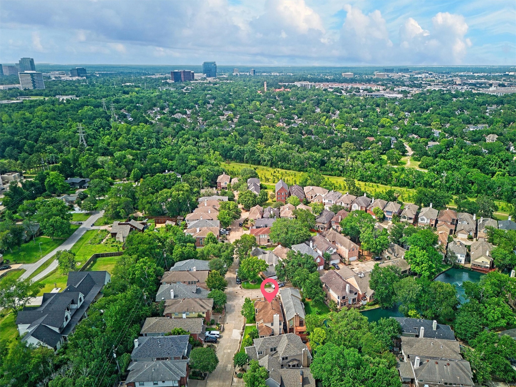12929 Kingsbridge Lane Houston, TX 77077 - Photo 40 of 42 Stunning aerial view highlighting this home’s exceptional location surrounded by mature trees, scenic green space, and beautiful established homes throughout the community. Buyers will love the peaceful neighborhood atmosphere combined with convenient access to major business districts, shopping, dining, entertainment, and commuter routes. This prime location offers the perfect blend of privacy, nature, and city convenience while showcasing the strong curb appeal and desirable setting of the property.