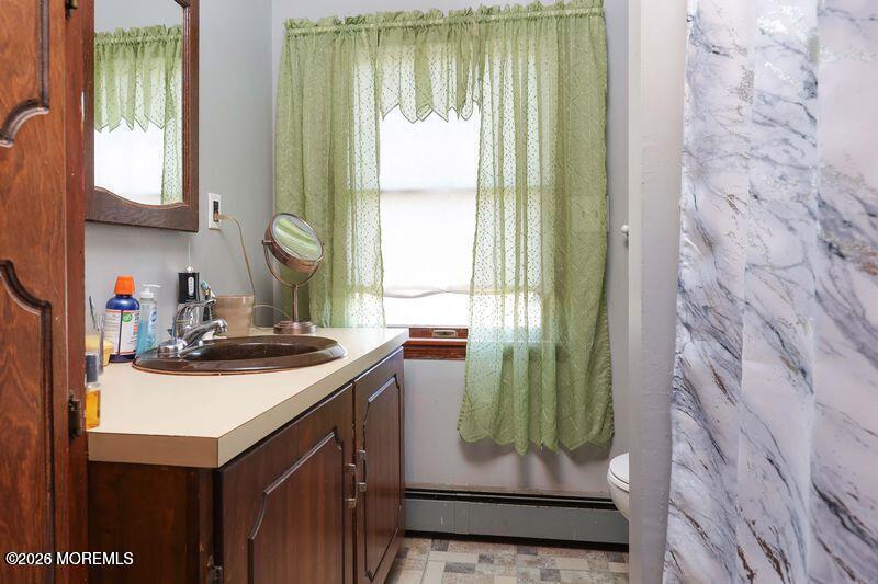 47-49 Appleton Avenue Leonardo, NJ 07737 - Photo 10 of 15 a kitchen with a sink a kitchen island a stove and a window