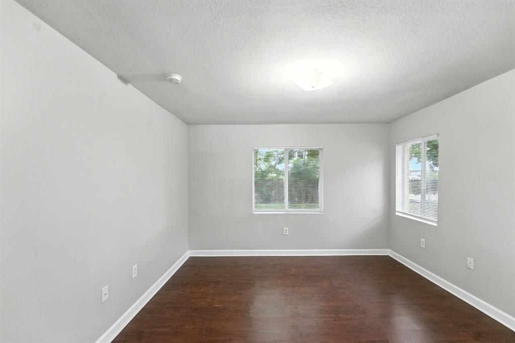 25355 Southwest 135th Court Homestead, FL 33032 - Photo 15 of 40 an empty room with wooden floor and windows
