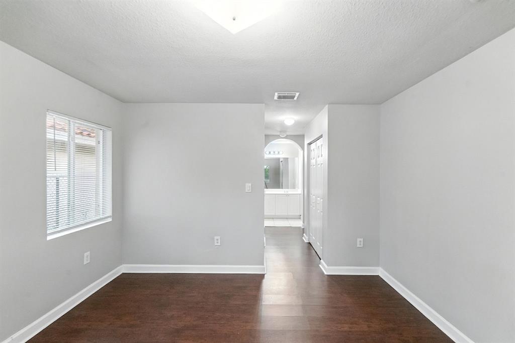 25355 Southwest 135th Court Homestead, FL 33032 - Photo 16 of 40 wooden floor in an empty room with a window
