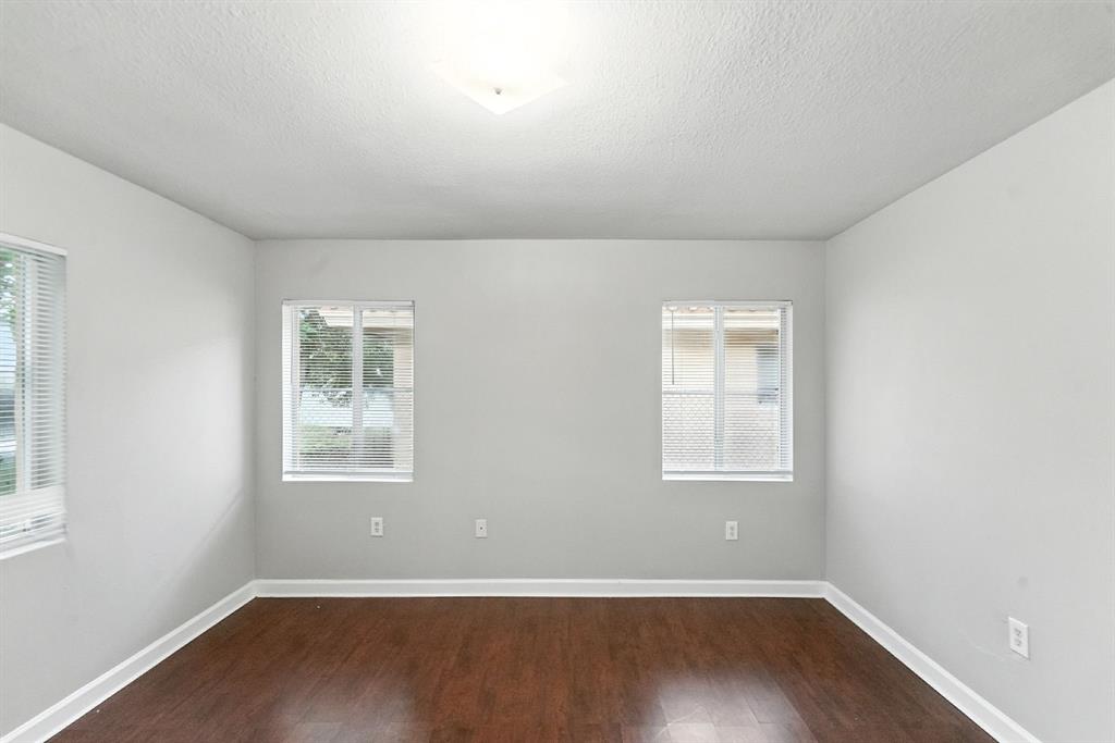 25355 Southwest 135th Court Homestead, FL 33032 - Photo 17 of 40 an empty room with wooden floor and windows
