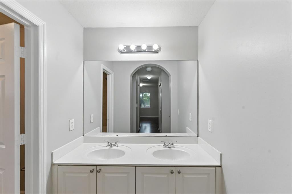 25355 Southwest 135th Court Homestead, FL 33032 - Photo 18 of 40 a bathroom with a sink and a mirror