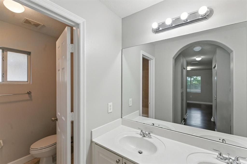 25355 Southwest 135th Court Homestead, FL 33032 - Photo 19 of 40 a bathroom with a toilet a sink and mirror