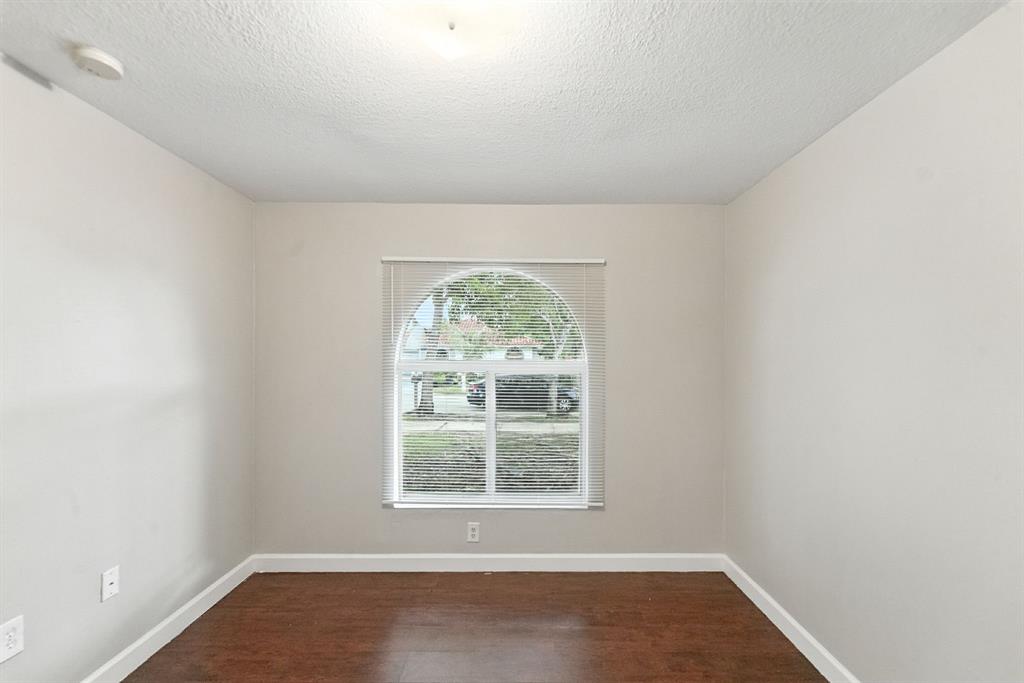25355 Southwest 135th Court Homestead, FL 33032 - Photo 22 of 40 an empty room with wooden floor and windows