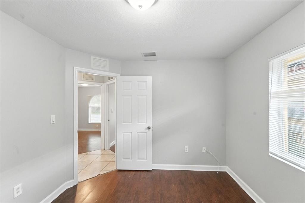 25355 Southwest 135th Court Homestead, FL 33032 - Photo 25 of 40 an empty room with wooden floor and windows