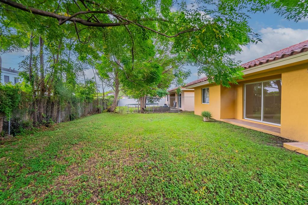 25355 Southwest 135th Court Homestead, FL 33032 - Photo 37 of 40 a view of a backyard with plants and large trees