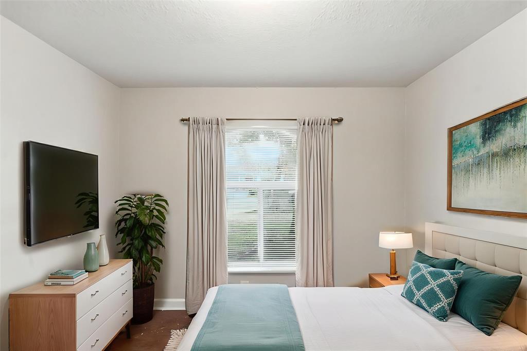 25355 Southwest 135th Court Homestead, FL 33032 - Photo 4 of 40 a bedroom with a bed and a flat screen tv