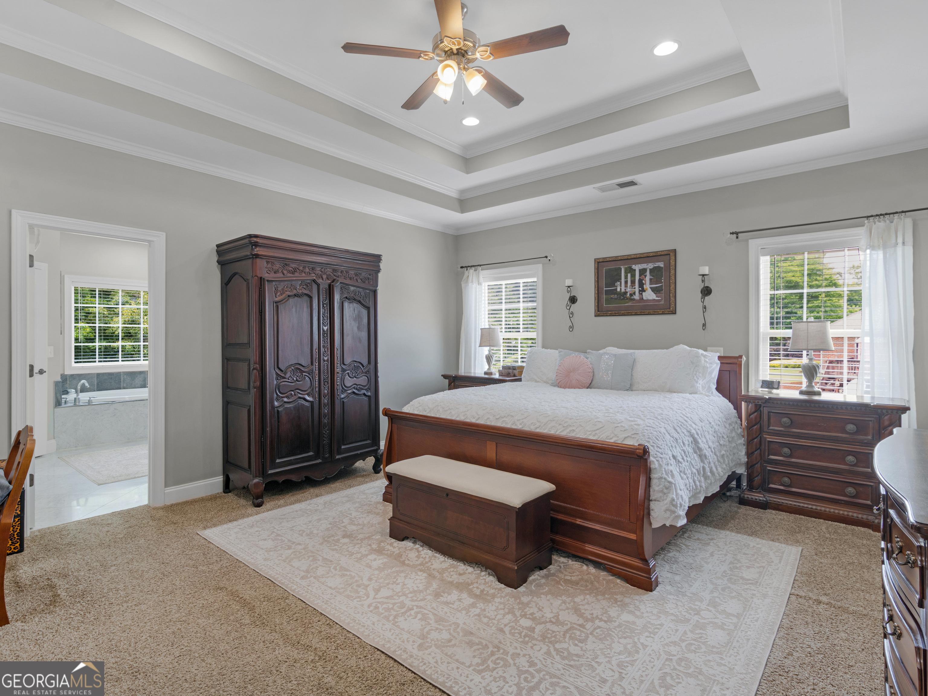 221 Hummingbird Court Hampton, GA 30228 - Photo 40 of 77 a spacious bedroom with a bed and a chandelier