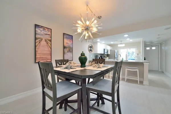 a dining room with furniture and chandelier