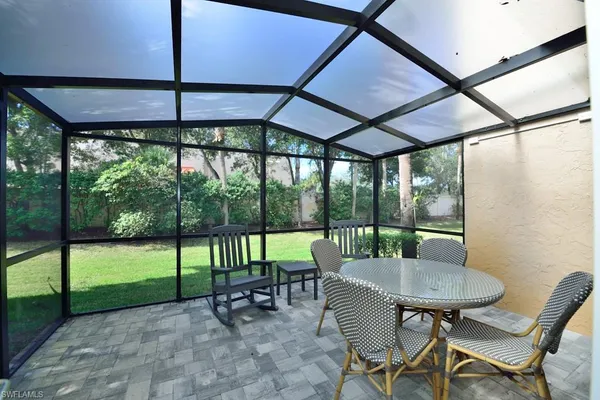a view of a patio with a table chairs and a table
