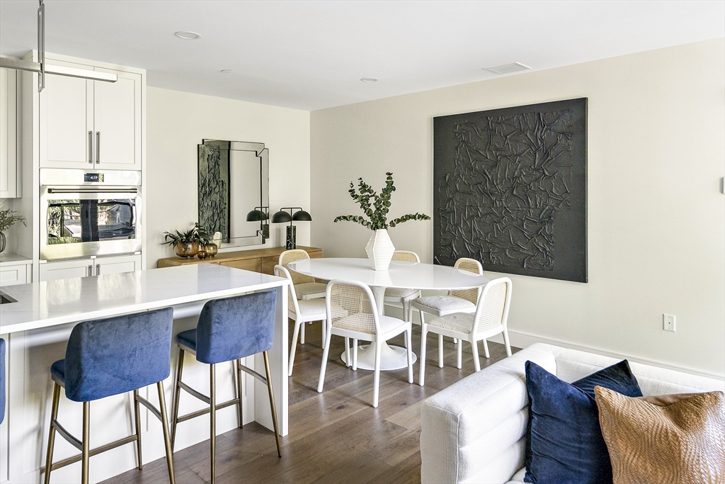 20 Kinmonth Road, Unit 301 Newton, MA 02468 - Photo 15 of 30 a view of a dining room with furniture and wooden floor