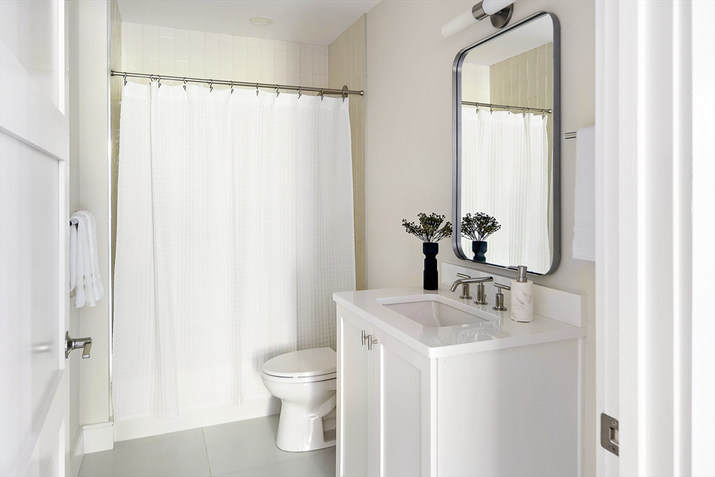 20 Kinmonth Road, Unit 301 Newton, MA 02468 - Photo 16 of 30 a bathroom with a sink a toilet and shower