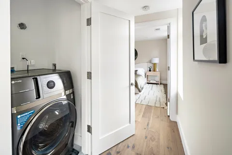 a view of a hallway with washer and dryer