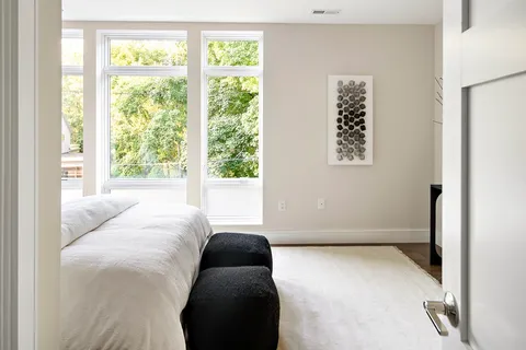 a bedroom with a bed and a window