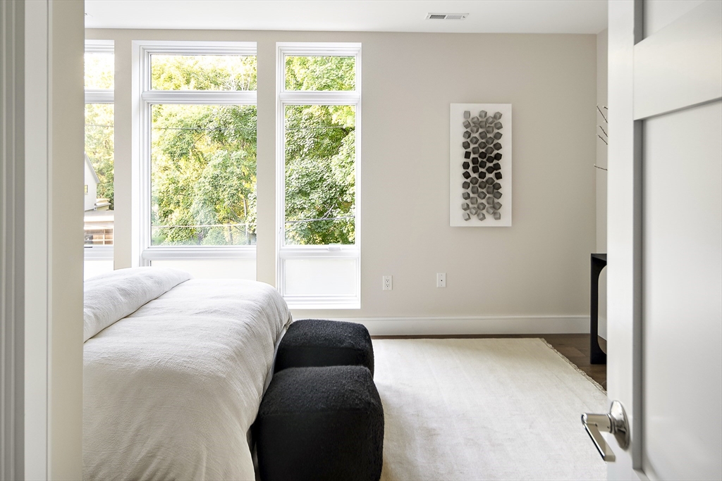 20 Kinmonth Road, Unit 301 Newton, MA 02468 - Photo 25 of 30 a bedroom with a bed and a window