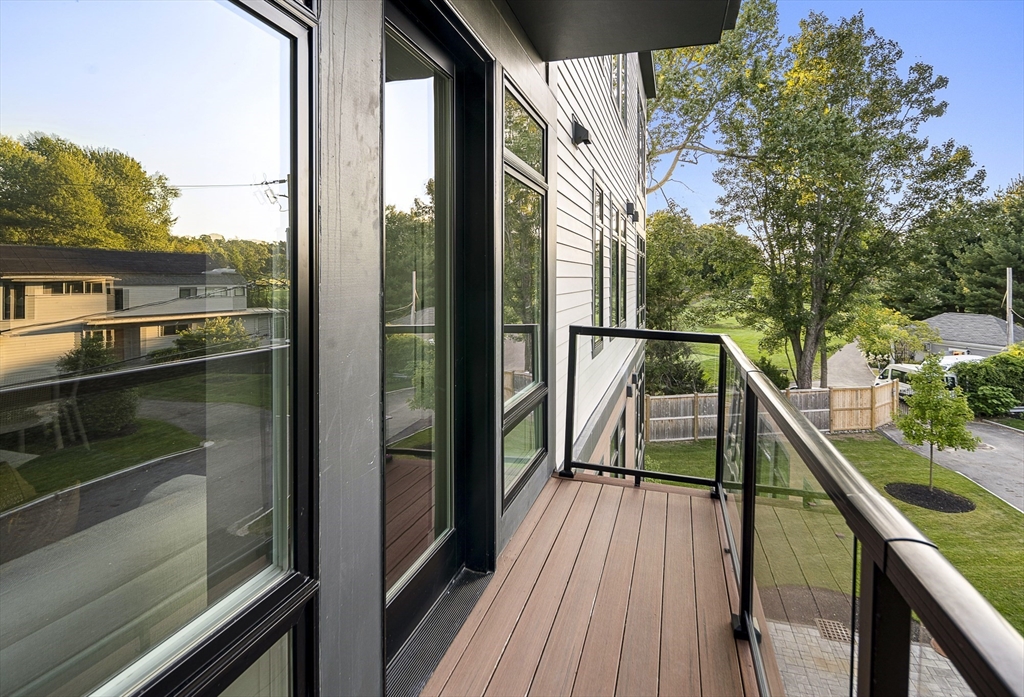 20 Kinmonth Road, Unit 301 Newton, MA 02468 - Photo 5 of 30 a view of a balcony with wooden floor and fence