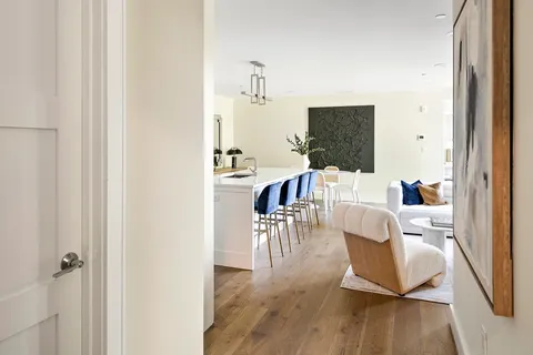 a living room with furniture wooden floor and a flat screen tv