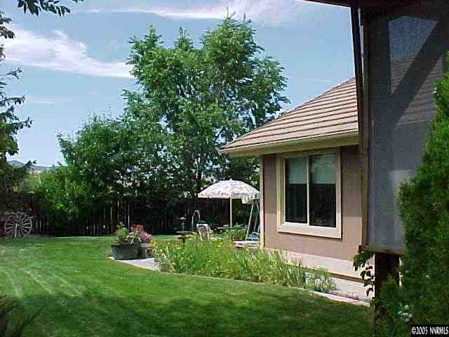13180 Fellowship Way Reno, NV 89511 - Photo 2 of 9 a front view of a house with a yard table and chairs