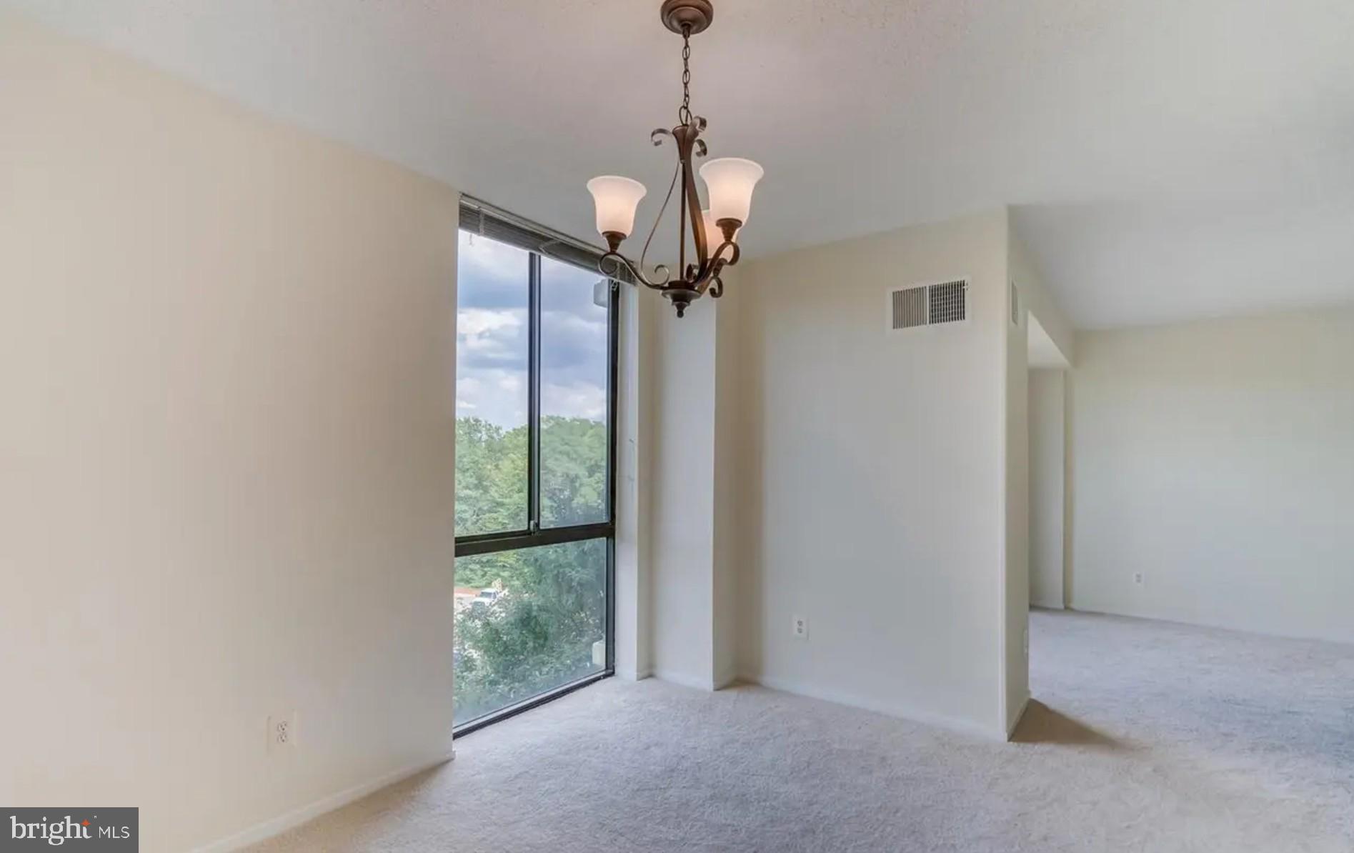 2311 Pimmit Drive, Unit 808 Falls Church, VA 22043 - Photo 11 of 24 a view of a livingroom with a chandelier fan and a window