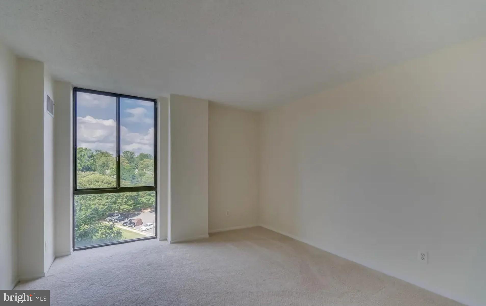 2311 Pimmit Drive, Unit 808 Falls Church, VA 22043 - Photo 19 of 24 a view of an empty room with wooden floor and a window