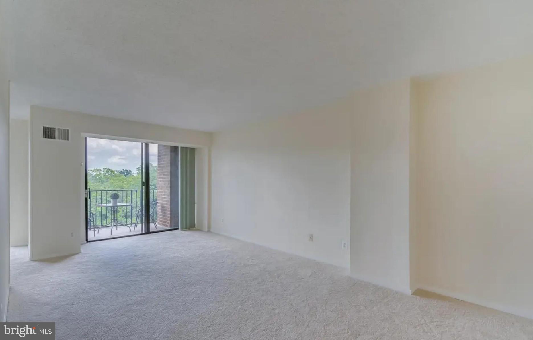 2311 Pimmit Drive, Unit 808 Falls Church, VA 22043 - Photo 6 of 24 a view of an empty room with wooden floor and a window