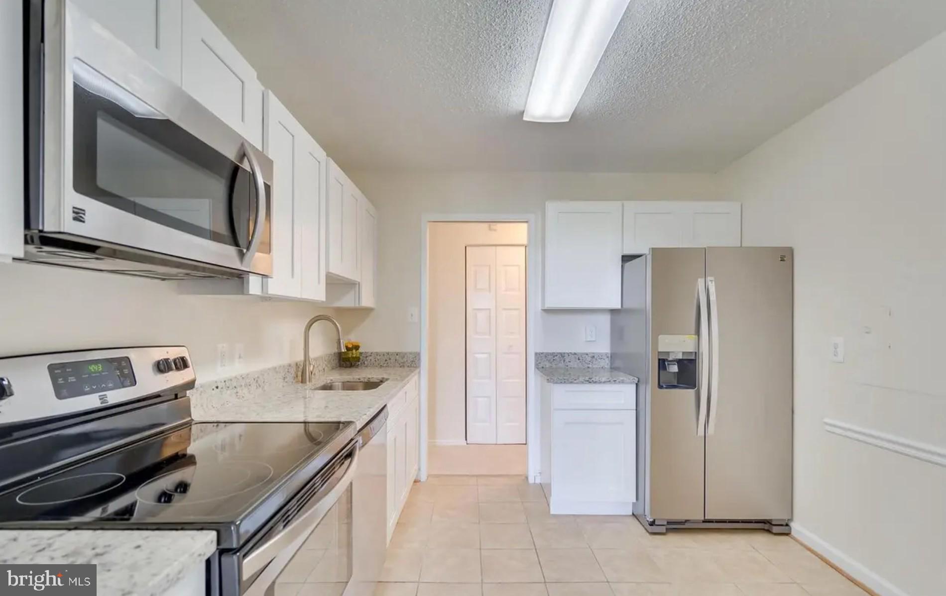 2311 Pimmit Drive, Unit 808 Falls Church, VA 22043 - Photo 9 of 24 a kitchen with stainless steel appliances granite countertop a refrigerator stove and sink