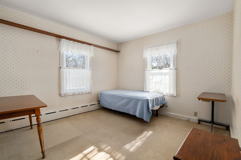 34 Chicopee Street New Bedford, MA 02745 - Photo 10 of 15 a bedroom with a bed and a window