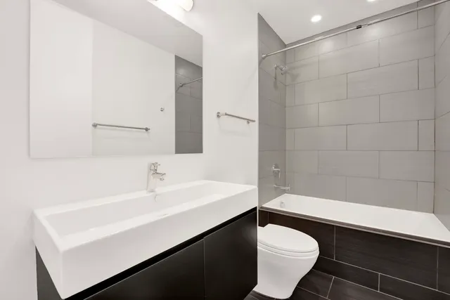 an empty room with wooden floor and entrance