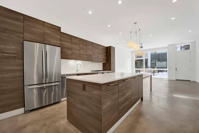an empty room with wooden floor and chairs