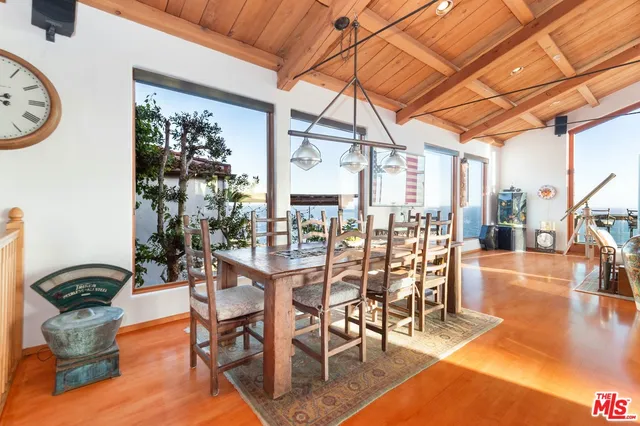 a dining room with furniture wooden floor and a clock