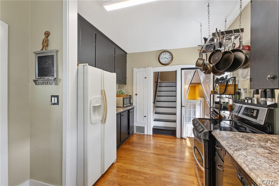 149 Harding Street Syracuse, NY 13208 - Photo 22 of 43 This is looking from the eat-in area of the kitchen towards the 2nd floor staircase and also the staircase to the side entrance to home and the basement