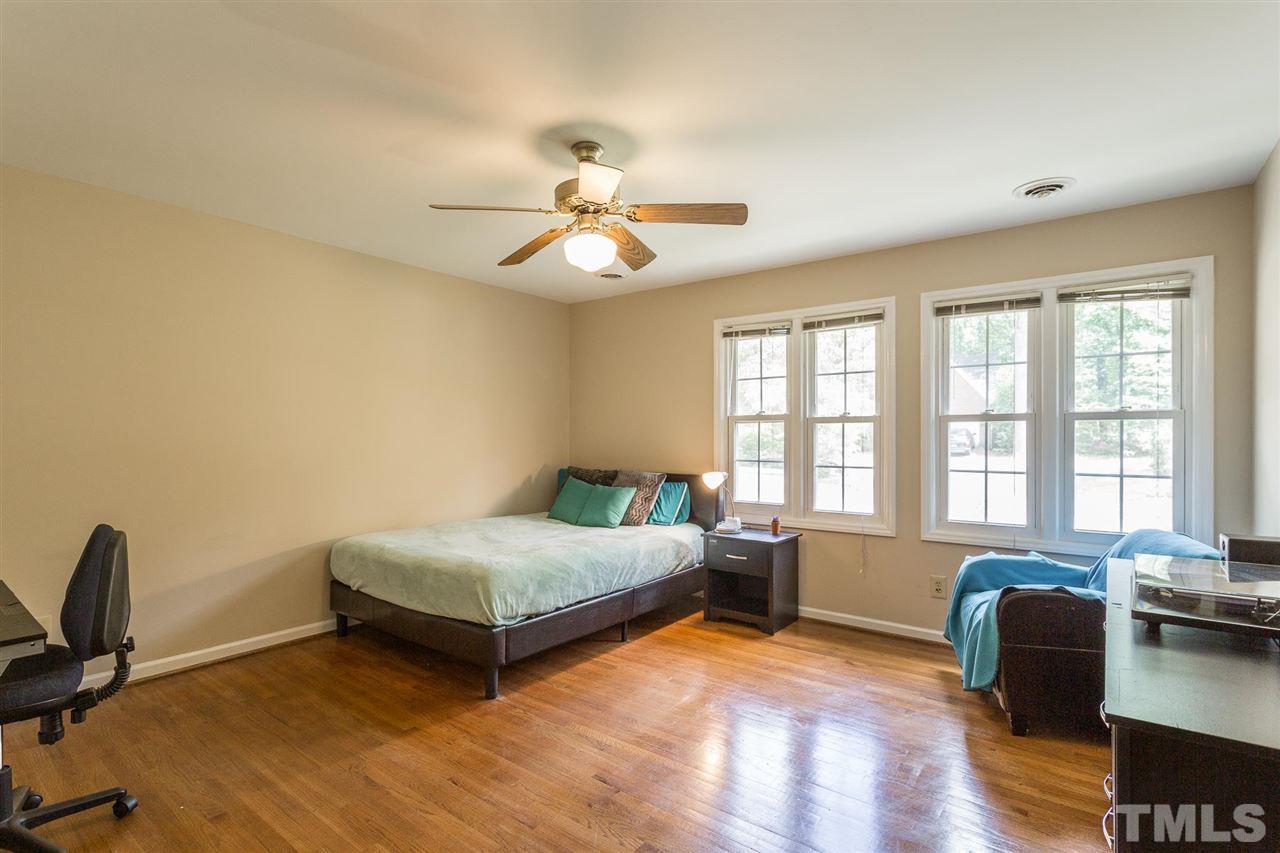 7809 Harps Mill Road Raleigh, NC 27615 - Photo 24 of 30 Bedroom #4 features hardwood floors and a ceiling fan.