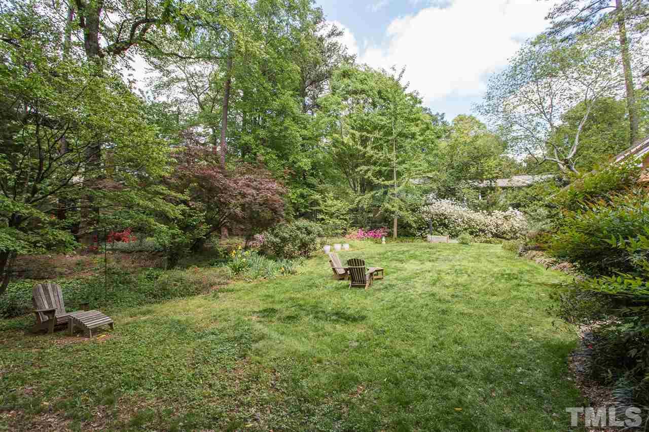 7809 Harps Mill Road Raleigh, NC 27615 - Photo 30 of 30 The backyard is filled with lush landscaping. It is very private and fenced.