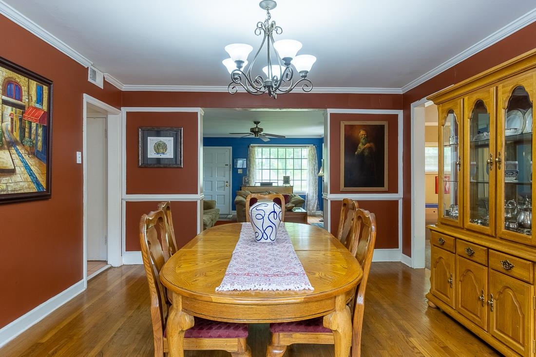 87 South Fernway Road Memphis, TN 38117 - Photo 7 of 28 a view of a dining room with furniture a chandelier and wooden floor