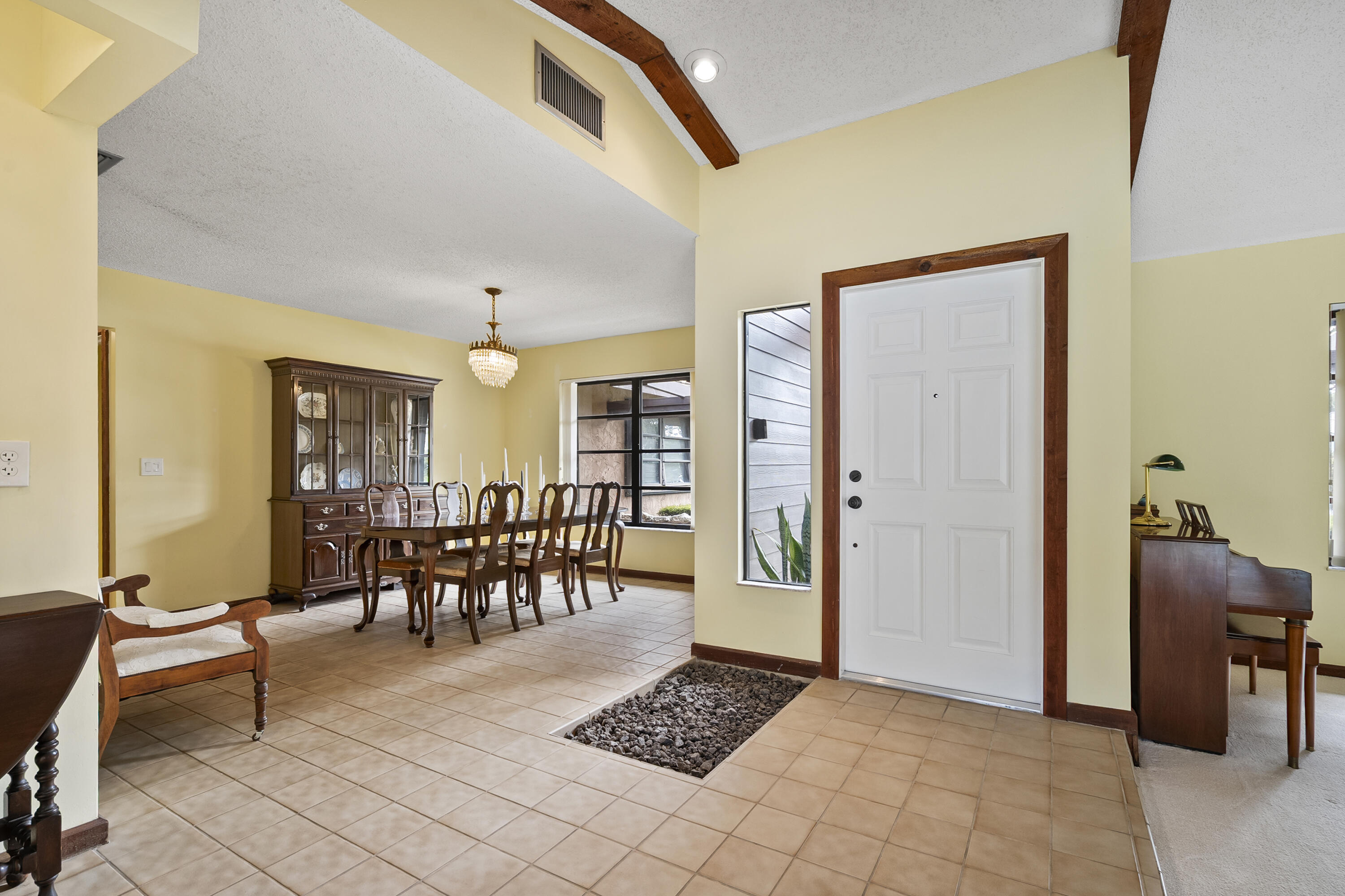 18815 South Golden Hawk Trail Jupiter, FL 33458 - Photo 13 of 49 a living room with furniture a dining table and a potted plant