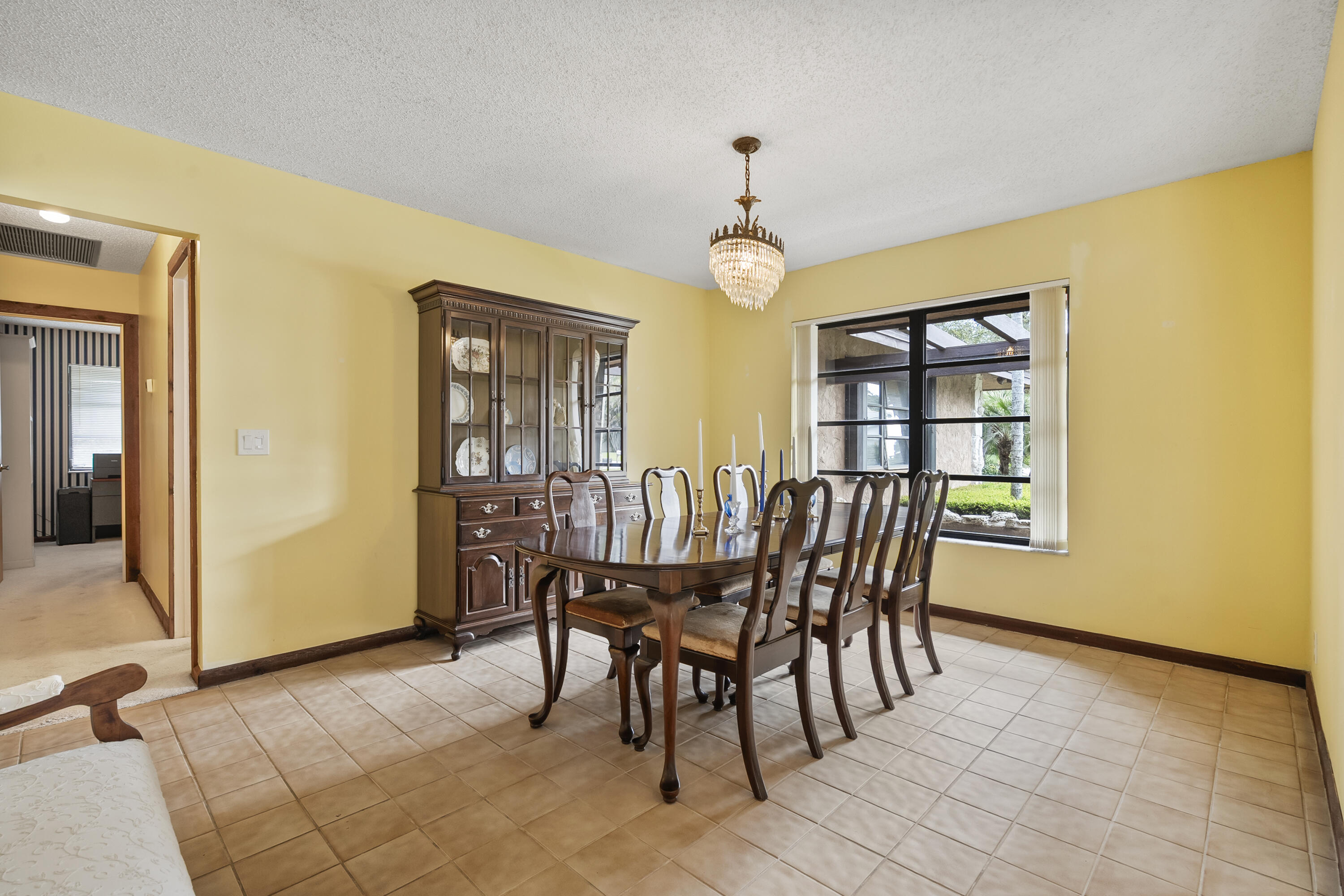 18815 South Golden Hawk Trail Jupiter, FL 33458 - Photo 14 of 49 a view of a dining room with furniture and chandelier