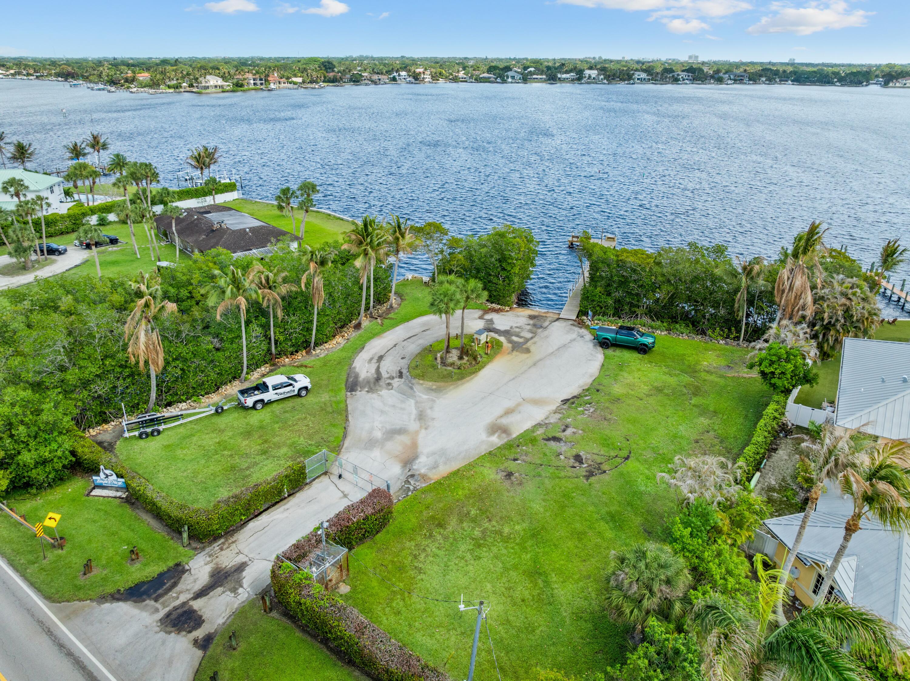 18815 South Golden Hawk Trail Jupiter, FL 33458 - Photo 2 of 49 an aerial view of a house with a yard and lake view