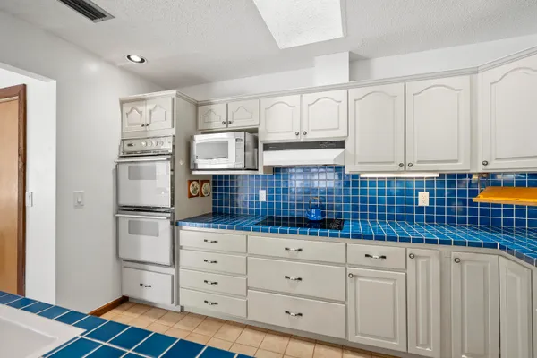 a kitchen with stainless steel appliances a refrigerator sink and cabinets