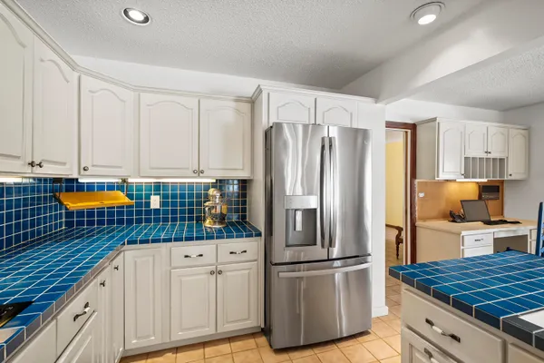 a kitchen with stainless steel appliances granite countertop a refrigerator sink and cabinets