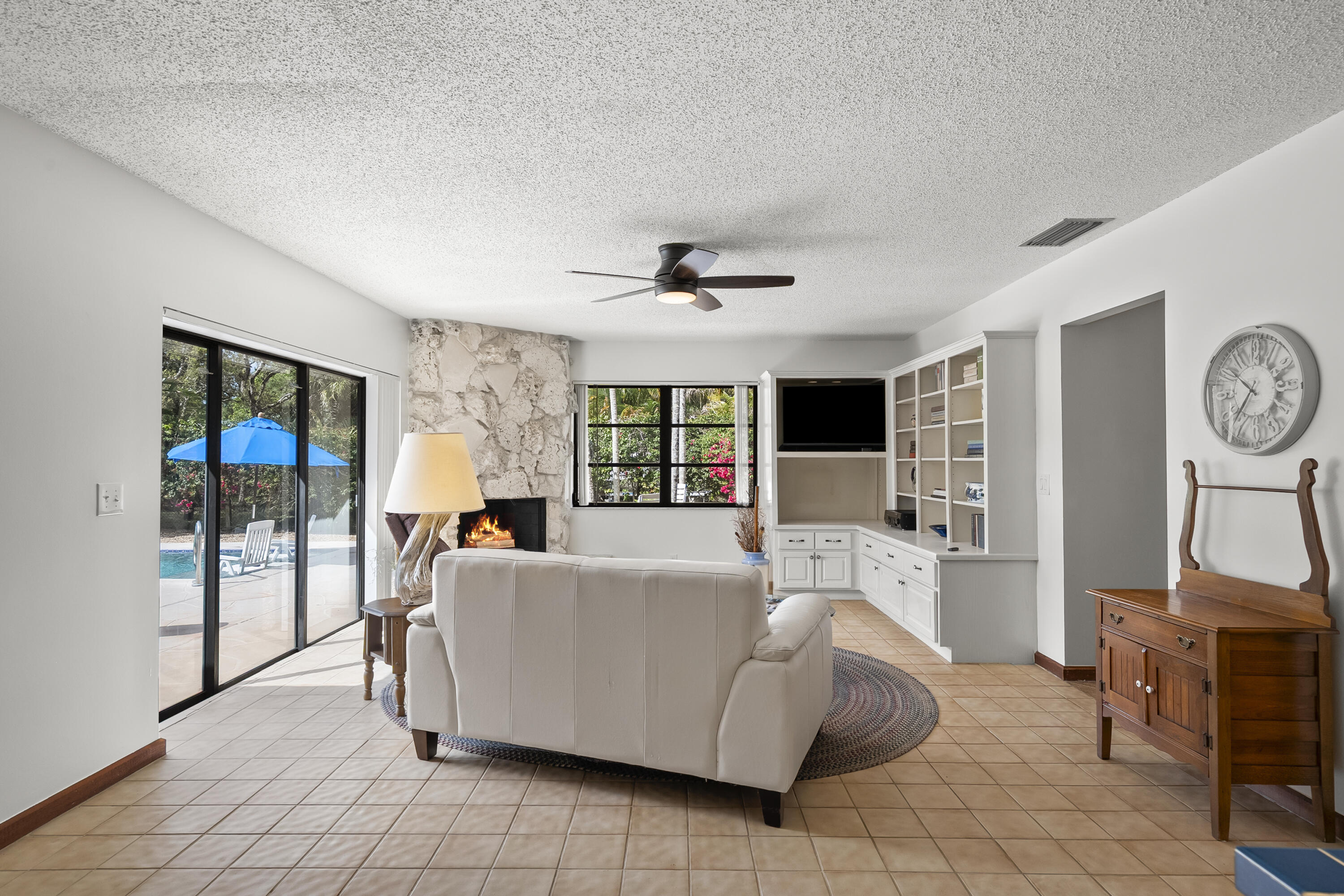 18815 South Golden Hawk Trail Jupiter, FL 33458 - Photo 24 of 49 a living room with furniture a flat screen tv and a large window