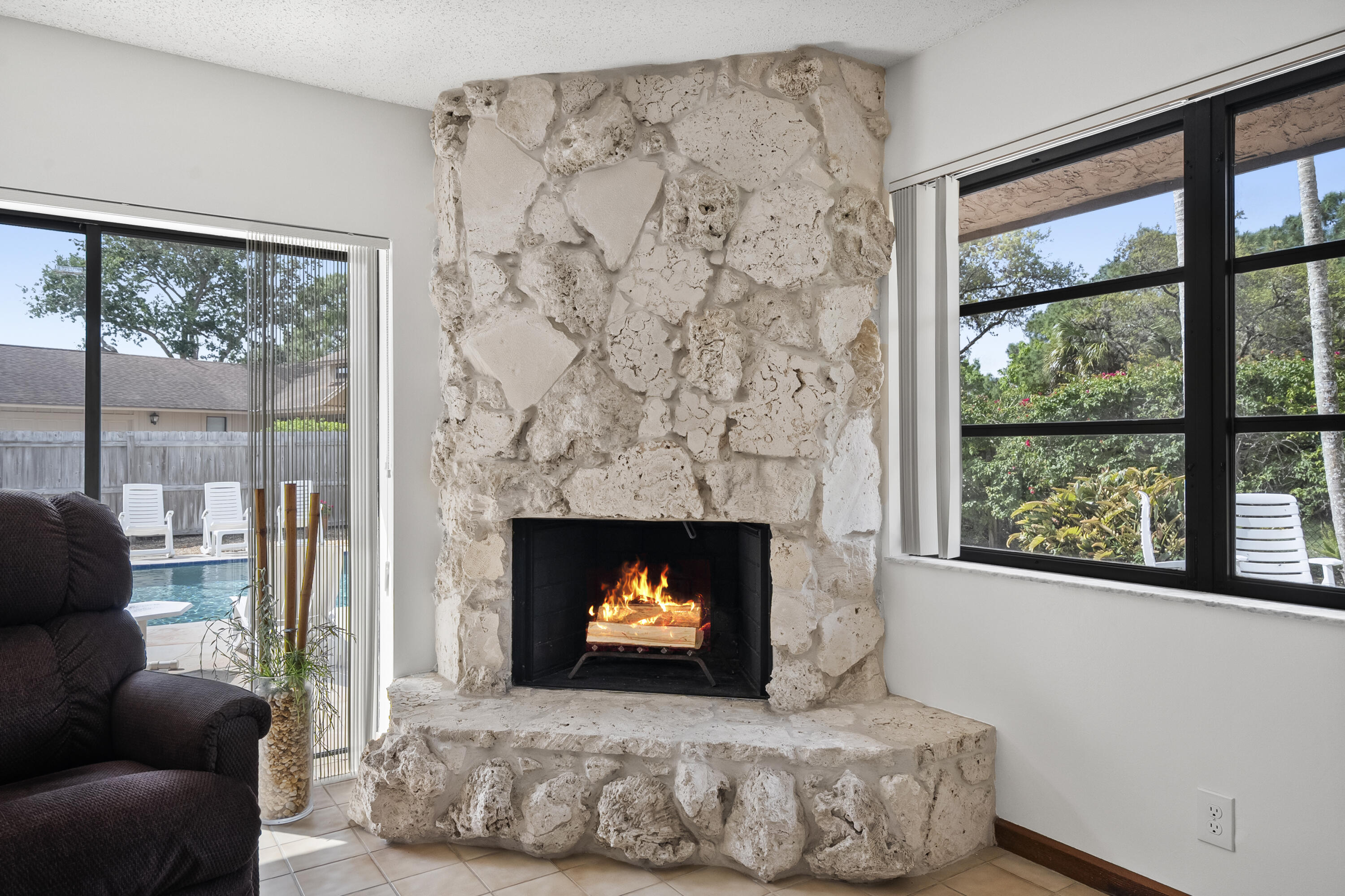 18815 South Golden Hawk Trail Jupiter, FL 33458 - Photo 25 of 49 a living room with a fireplace and a large window