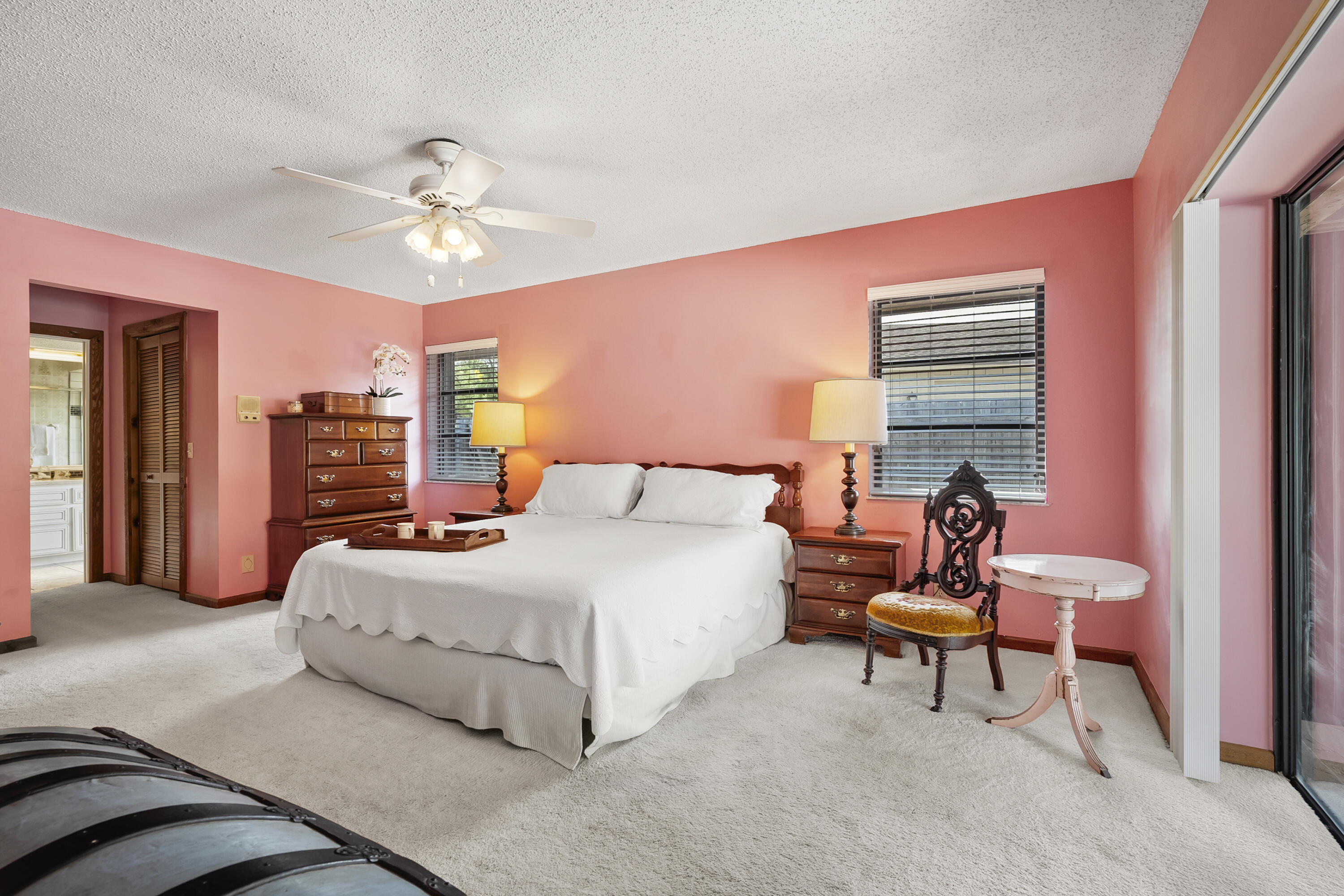 18815 South Golden Hawk Trail Jupiter, FL 33458 - Photo 28 of 49 a bedroom with a bed and a chandelier