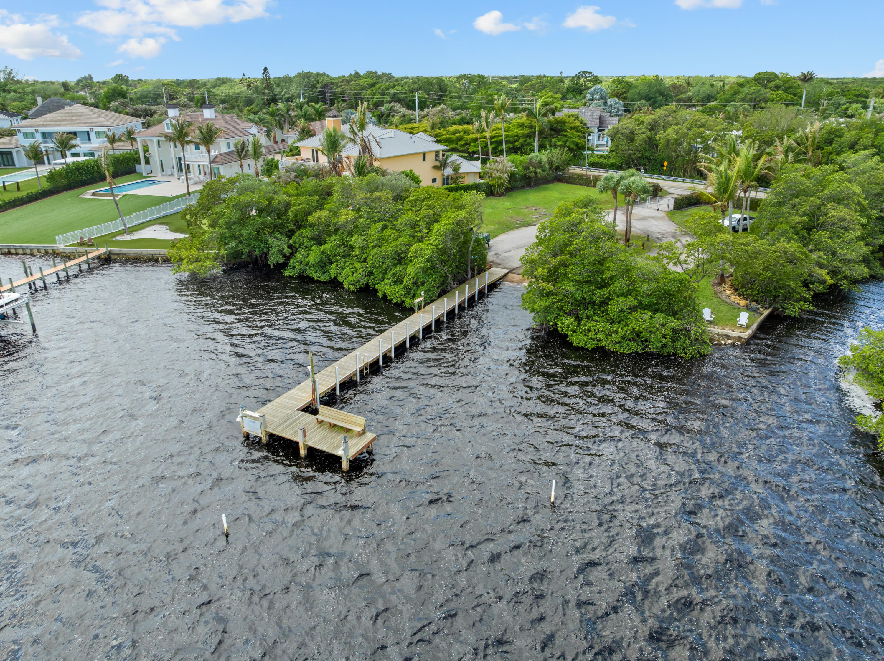 18815 South Golden Hawk Trail Jupiter, FL 33458 - Photo 3 of 49 an aerial view of a house with a yard and lake view