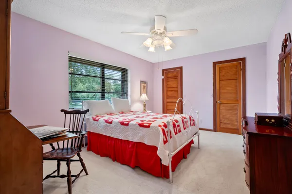 a bedroom with a bed and window