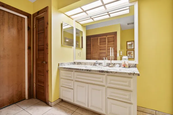 a bathroom with a granite countertop shower and a toilet