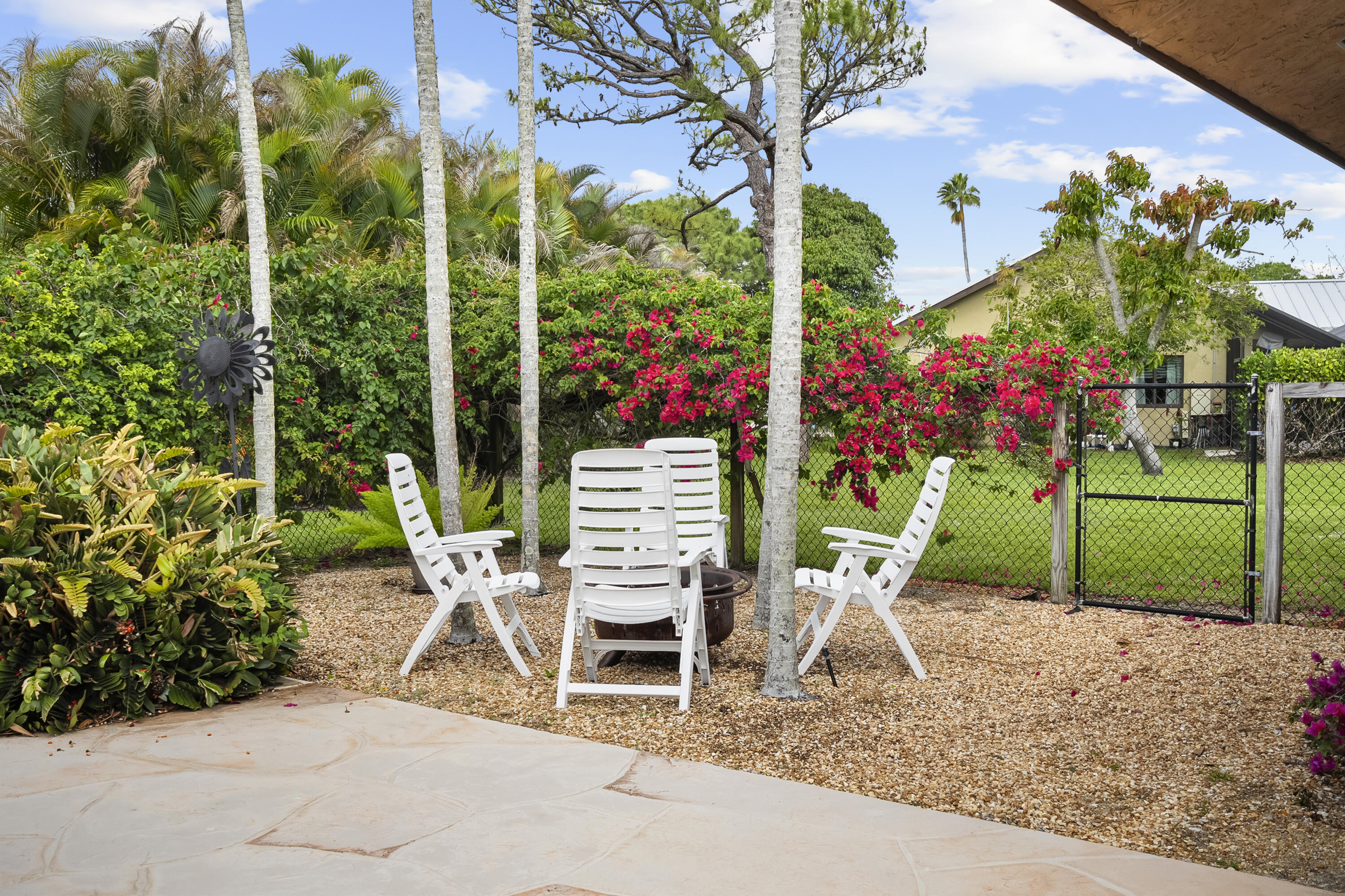 18815 South Golden Hawk Trail Jupiter, FL 33458 - Photo 40 of 49 a view of a chairs and table in the garden