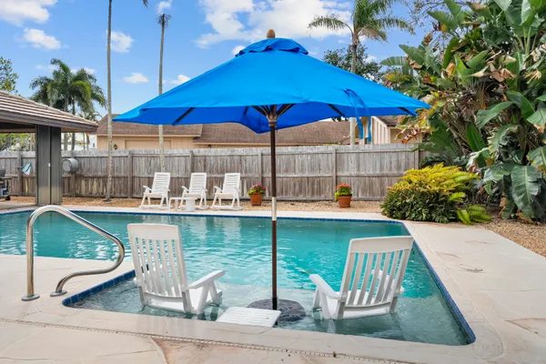 a view of a chairs and table in the patio
