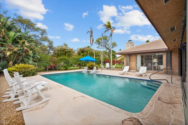 swimming pool view with a garden space